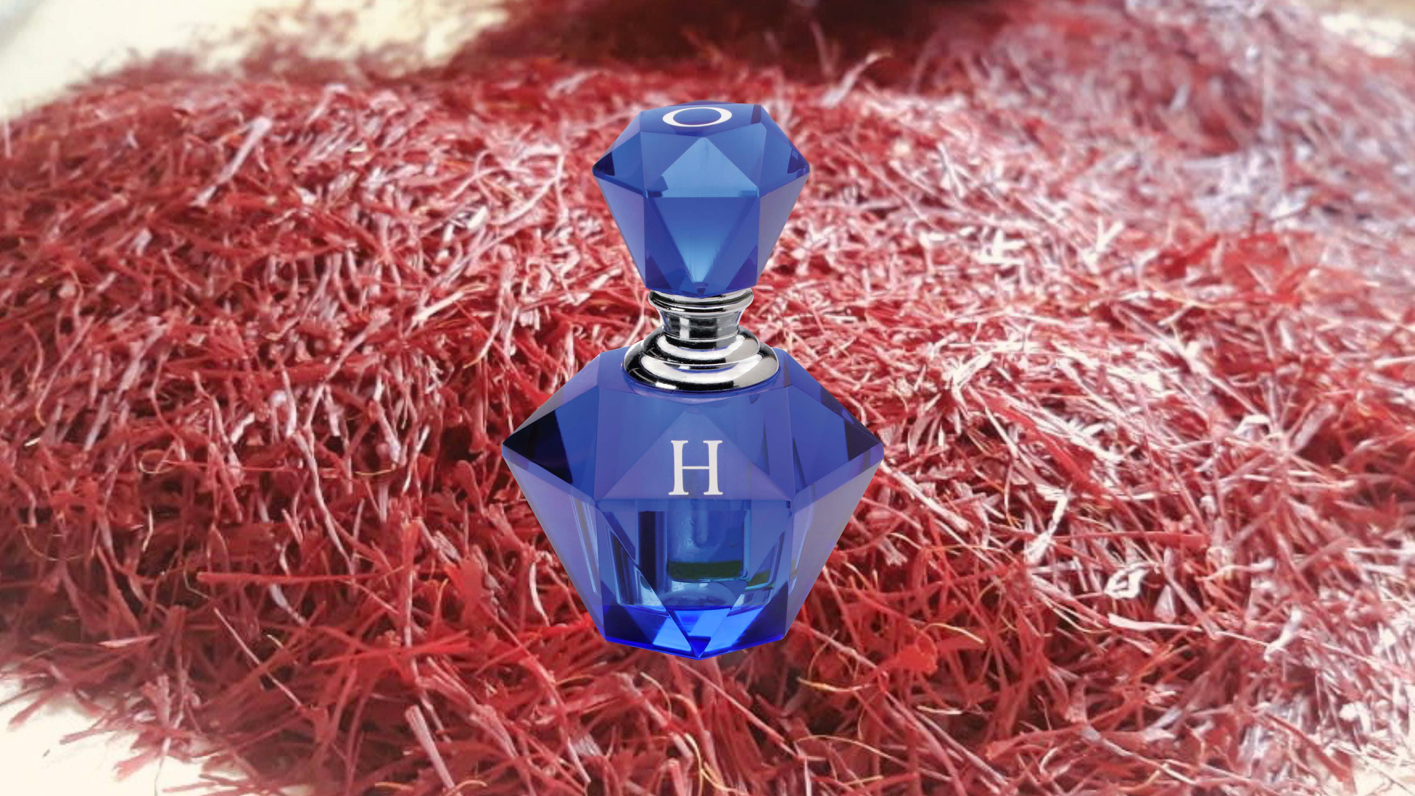 A blue perfume bottle and jasmin flowers in the background