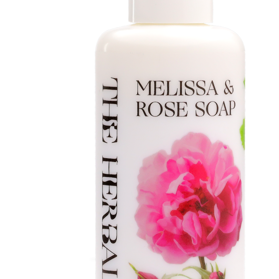 A white bottle with pump showing on the label melissa & rose soa, rosa damascena flower and The Herball logo.